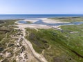 Aerial image of dutch national park slufter with curving rivers in grass land towards the north sea on the island of Texel