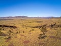 Aerial image of Karijini National Park close to Mount Bruce yellow grass and red dust