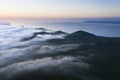 Aerial image with magical sunset over a low cloud layer covering Pico Island, with the northcoast and Sao Jorge Island in the