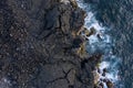 Aerial image showing the typical black lava basalt coastline of Ilha do Pico Island in the Azores Royalty Free Stock Photo