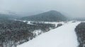 Aerial image from the top of snowy mountain pines in the middle of the winter Royalty Free Stock Photo