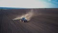 Aerial image of a tractor with seedbed cultivator ploughs field