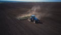 Aerial image of a tractor with seedbed cultivator ploughs field