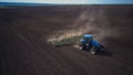 Aerial image of a tractor with seedbed cultivator ploughs field