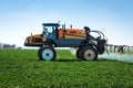 Aerial image of tractor spraying soil and young crop in springtime in field Royalty Free Stock Photo