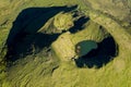 Aerial image of typical green volcanic caldera crater landscape with volcano cones of Planalto da Achada central plateau of Ilha