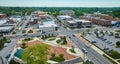 Aerial with James Cultural Plaza with distant courthouse in downtown Auburn