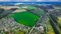 aerial landmark landscape photography from drone of suburban view with cottages and country side field in edge season of summer