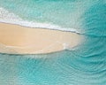 Aerial landscape of a beach at sunrise with stunning blue water