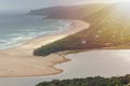Aerial landscape of beautiful sandy beach, forest and mountains at sunset Royalty Free Stock Photo