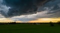 Aerial landscape of countryside with colorful storm clouds. Extreme thunderstorm over a farm and agricultural fields and Royalty Free Stock Photo