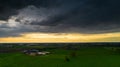 Aerial landscape of countryside with colorful storm clouds. Extreme thunderstorm over a farm and agricultural fields and Royalty Free Stock Photo
