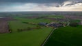 Aerial landscape of countryside with colorful storm clouds. Extreme thunderstorm over a farm and agricultural fields and Royalty Free Stock Photo