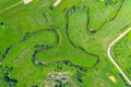 Aerial landscape countryside of winding small river, stream in green field, top view meadow Royalty Free Stock Photo