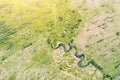 Aerial landscape countryside of winding small river, stream in green field, top view meadow Royalty Free Stock Photo