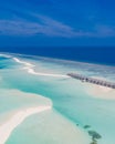 Aerial landscape, luxury tropical resort with water villas. Island beach, palm trees, sunny sky. Amazing bird eyes