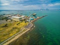 Aerial landscape of parking lot and industrial wharfs near ocean coastline at Williamstown suburb with Melbourne CBD skyline in th