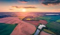 Aerial landscape photography. Exciting summer sunrise on Ternopil outskirts with smal lake and asphalt road. Royalty Free Stock Photo