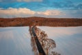 Aerial landscape of the road through snowy field at winter, Poland Royalty Free Stock Photo