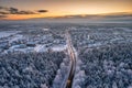 Aerial landscape of the road through snowy forest at winter, Poland Royalty Free Stock Photo