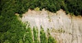 Aerial landscape of rocky terrain with trees on background.