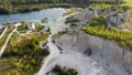 Aerial landscape Sand Hills of Quarry With a Pond and Abandoned Prison in Rummu Estonia Europe.