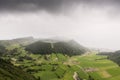 Aerial landscape showing bad weather over Caldeira do Alferes, a caldeira within the large volcano crater of Sete Cidades on SÃÂ£o Royalty Free Stock Photo