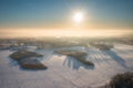 Aerial landscape of the snowy meadow at winter sunrise, Poland Royalty Free Stock Photo