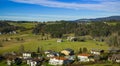 Aerial landscape top view of European village country side Austrian outskirts landmark houses on highland spring time valley with Royalty Free Stock Photo