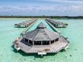 Aerial landscape view of the beautiful over water wooden hut in the ocean at the tropical island Royalty Free Stock Photo