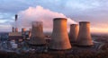 Aerial landscape view of cooling towers with pollution emissions at sunset Royalty Free Stock Photo