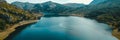 aerial landscape view with drone of beautiful lake in mountains in a sunny day with blue sky a very popular tourist Royalty Free Stock Photo