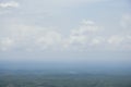 Aerial landscape view with a drone of meadow and cloudy sky horizon. Beautiful natural view of green fields and sky. Foggy weather