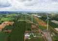 Aerial landscape view of group of windmills in a wind farm creating renewable energy at Nakhon Ratchasima, Thailand