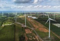 Aerial landscape view of group of windmills in a wind farm creating renewable energy at Nakhon Ratchasima, Thailand