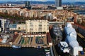 Aerial landscape view of harbor in Barcelona. Large colorful fishing nets on the ground. Unfinished large ship under repairing ong