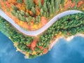 Autumnal landscape view of a mountain road and a lake Royalty Free Stock Photo