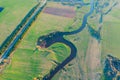 Aerial landscape of winding meanders small river, stream in green field, top evening sunset view meadow Royalty Free Stock Photo