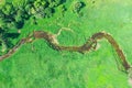 Aerial landscape of winding small river, stream in green field, top view meadow Royalty Free Stock Photo