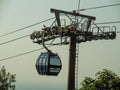 Aerial lift passes through the mountains and forest.