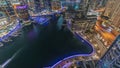 Aerial view to Dubai marina skyscrapers around canal with floating boats night timelapse Royalty Free Stock Photo