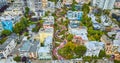 Aerial looking at Lombard Street and houses from further back with cars going down red brick road