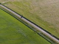 Aerial of meadowland separated by straight bicycle lane on the dutch island of Texel Royalty Free Stock Photo