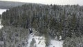 Aerial of magic snowy winter wonderland with a small glamping unbuilt house among trees. Clip. Winter season in snowy Royalty Free Stock Photo