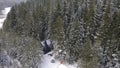 Aerial of magic snowy winter wonderland with a small glamping unbuilt house among trees. Clip. Winter season in snowy Royalty Free Stock Photo