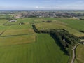 Aerial of meadowland with curving road and farms on the dutch island of Texel