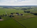 Aerial of meadowland and farms on the dutch island of Texel with the sea visible on the horizon