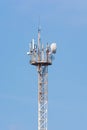 Aerial of mobile communication on a background of a blue cloudy sky. High antenna. Sun rays and glare. The concept of mobile Royalty Free Stock Photo