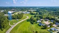 Aerial neighborhood with houses around culdesac and road leading to backside of water tower Royalty Free Stock Photo