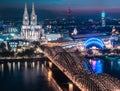 Aerial night panorama of the illuminated Hohenzollern bridge over Rhine river. Beautiful cityscape of Cologne, Germany Royalty Free Stock Photo